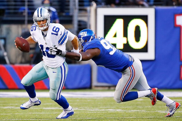 EAST RUTHERFORD, NJ - OCTOBER 25:  Matt Cassel #16 of the Dallas Cowboys escapes the tackle attempt by George Selvie #93 of the New York Giants during the second quarter at MetLife Stadium on October 25, 2015 in East Rutherford, New Jersey.  (Photo by Al Bello/Getty Images)