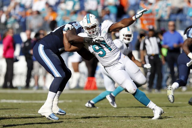 Miami Dolphins defensive end Cameron Wake (91) battles Tennessee Titans tackle Jamon Meredith, left, in the second half of an NFL football game Sunday, Oct. 18, 2015, in Nashville, Tenn. (AP Photo/Weston Kenney)