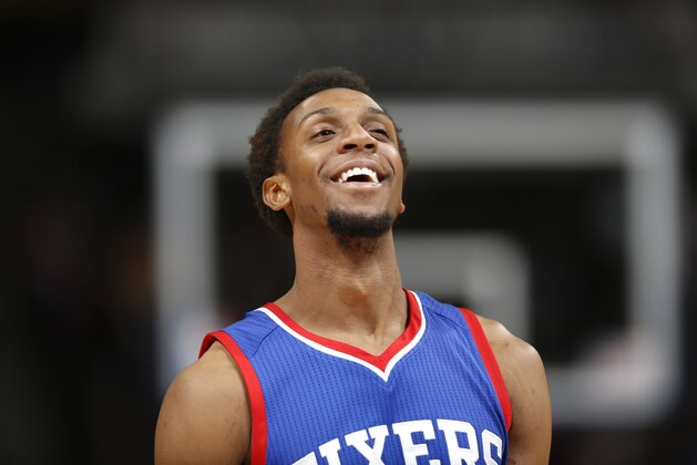 Philadelphia 76ers guard Ish Smith smiles as time runs out in the 76ers' NBA basketball game against the Denver Nuggets on Wednesday, March 25, 2015, in Denver. Philadelphia won 99-85. (AP Photo/David Zalubowski)