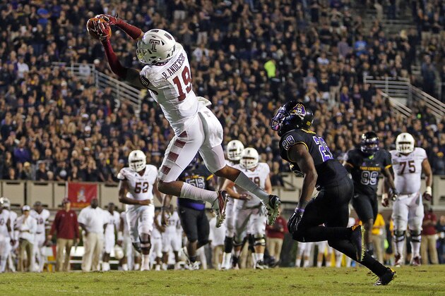 Temple's Robby Anderson (19) hauls in the go ahead  touchdown pass in front of East Carolina's Josh Hawkins (28) during the second half of an NCAA college football game in Greenville, N.C., Thursday, Oct. 22, 2015. Temple won 24-14. (AP Photo/Karl B DeBlaker)