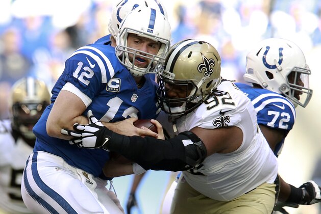 Indianapolis Colts quarterback Andrew Luck (12) is sacked by New Orleans Saints defensive tackle John Jenkins (92) in the second half of an NFL football game in Indianapolis, Sunday, Oct. 25, 2015. (AP Photo/R Brent Smith)