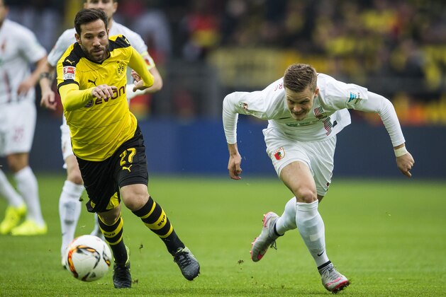 Augsburg's defender Philipp Max and Dortmund's midfielder Gonzalo Castro (L) vie for the ball during the German first division football Bundesliga match between Borussia Dortmund and FC Augsburg on October 25, 2015 in Dortmund, western Germany. AFP PHOTO / ODD ANDERSEN
RESTRICTIONS: DURING MATCH TIME: DFL RULES TO LIMIT THE ONLINE USAGE TO 15 PICTURES PER MATCH AND FORBID IMAGE SEQUENCES TO SIMULATE VIDEO. 
==RESTRICTED TO EDITORIAL USE ==
FOR FURTHER QUERIES PLEASE CONTACT THE DFL DIRECTLY AT + 49 69 650050.        (Photo credit should read ODD ANDERSEN/AFP/Getty Images)