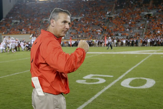 Ohio State head coach Urban Meyer celebrates during the closing moments of an NCAA college football game against Virginia Tech in Blacksburg, Va., Monday, Sept. 7, 2015. Ohio State won 42-24.  (AP Photo/Steve Helber)
