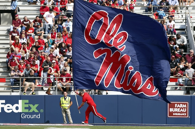 A Mississippi cheerleader runs along the end zone with an oversized Ole Miss flag following a score in the second half of an NCAA college football game in Oxford, Miss., Saturday, Oct. 10, 2015. No. 14 Mississippi won 52-3. (AP Photo/Rogelio V. Solis)