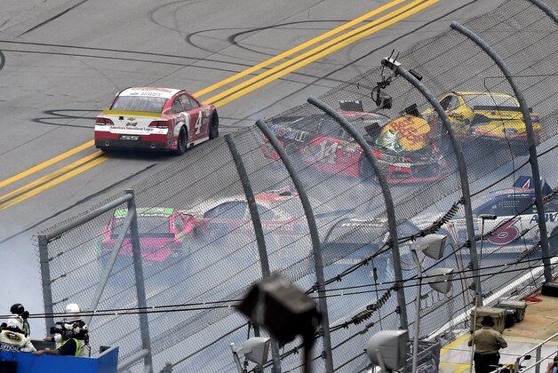 Sprint Cup Series driver Kevin Harvick (4) drives past a wreck involving Sprint Cup Series driver Tony Stewart (14), David Gilliland (38), Danica Patrick (10) Trevor Bayne (6) during the NASCAR Sprint Cup Series auto race at Talladega Superspeedway Sunday, Oct. 25, 2015, in Talladega, Ala. (AP Photo/ Mark Almond )