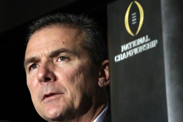 FILE- In this Jan. 13, 2014 file photo, Ohio State head coach Urban Meyer listens to a question during a news conference after the NCAA college football playoff championship game in Dallas. The pundits are talking up the Big Ten league this spring, largely because of the achievements and trend lines in the East Division. There was Ohio State’s national championship under Urban Meyer, Michigan State’s bowl win over a Baylor team that narrowly missed the College Football Playoff, Jim Harbaugh’s hiring at Michigan and Penn State’s rebuilding job under James Franklin. (AP Photo/David J. Phillip, File)
