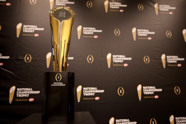 This Monday, July 14, 2014 photo shows the College Football Playoff National Championship Trophy in Irving, Texas. A rising gold football-shaped trophy will be the prize for the national champion in the new College Football Playoff. (AP Photo/Tony Gutierrez)