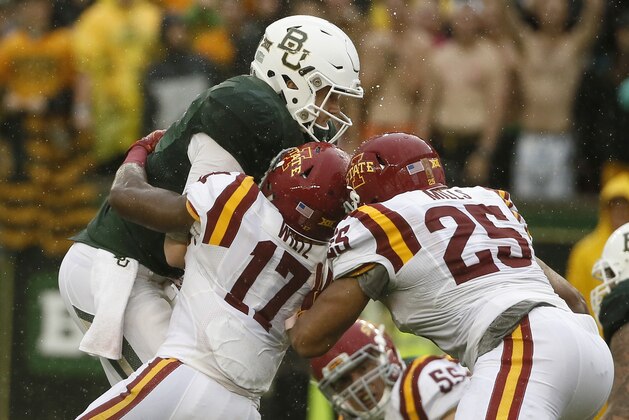 Baylor quarterback Seth Russell, left, is stopped on a running play by Iowa State defensive back Jomal Wiltz (17) and linebacker Brian Mills (25) during an NCAA college football game Saturday, Oct. 24, 2015, in Waco, Texas. (AP Photo/Tony Gutierrez)