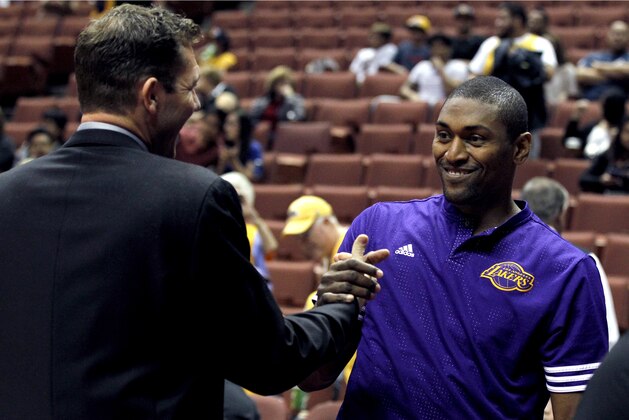 Los Angeles Lakers forward Metta World Peace, right, greets Golden State Warriors interim head coach Luke Walton before an NBA preseason basketball game in Anaheim, Calif., Thursday, Oct. 22, 2015. (AP Photo/Alex Gallardo)