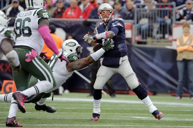 New York Jets defensive end Sheldon Richardson (91) knocks the ball from the hand of New England Patriots quarterback Tom Brady (12) during the second half of an NFL football game, Sunday, Oct. 25, 2015, in Foxborough, Mass. Brady recovered the ball.  (AP Photo/Steven Senne)