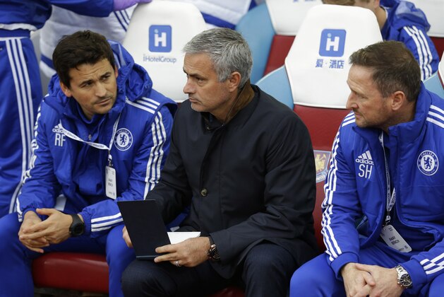 Chelsea's head coach Jose Mourinho, center, waits for the match to begin, prior to the English Premier League soccer match between West Ham and Chelsea at Upton Park stadium in London, Saturday, Oct. 24, 2015.  (AP Photo/Matt Dunham)