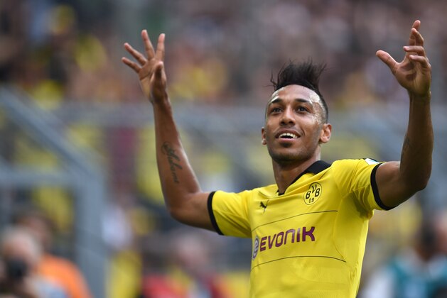 Dortmund's Gabonese striker Pierre-Emerick Aubameyang  celebrates scoring during the German first division Bundesliga football match Borussia Dortmund vs Borussia Moenchengladbach in Dortmund, western Germany, on August 15, 2015.  AFP PHOTO / PATRIK STOLLARZ

RESTRICTIONS: DURING MATCH TIME: DFL RULES TO LIMIT THE ONLINE USAGE TO 15 PICTURES PER MATCH AND FORBID IMAGE SEQUENCES TO SIMULATE VIDEO. 
== RESTRICTED TO EDITORIAL USE ==
FOR FURTHER QUERIES PLEASE CONTACT DFL DIRECTLY AT + 49 69 650050.        (Photo credit should read PATRIK STOLLARZ/AFP/Getty Images)