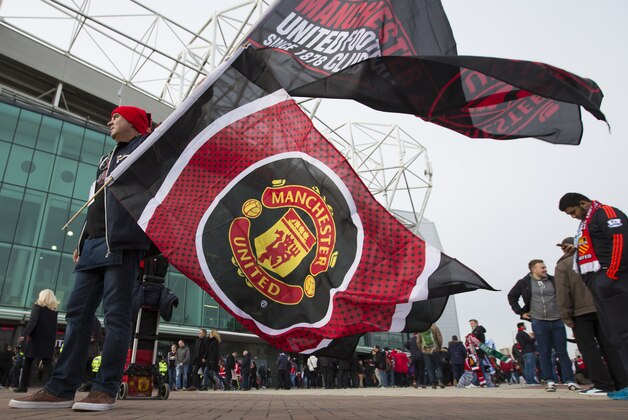 A vendor sells team flags before the English Premier League soccer match between Manchester United and Manchester City at Old Trafford Stadium, Manchester, England, Sunday, Oct. 25, 2015. (AP Photo/Jon Super)