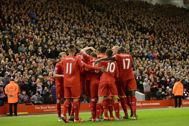 Liverpool players celebrate Benteke's opening goal during the English Premier League football match between Liverpool and Southampton at Anfield stadium in Liverpool, north west England on October 25, 2015. AFP PHOTO / OLI SCARFF

RESTRICTED TO EDITORIAL USE. No use with unauthorized audio, video, data, fixture lists, club/league logos or 'live' services. Online in-match use limited to 75 images, no video emulation. No use in betting, games or single club/league/player publications.        (Photo credit should read OLI SCARFF/AFP/Getty Images)