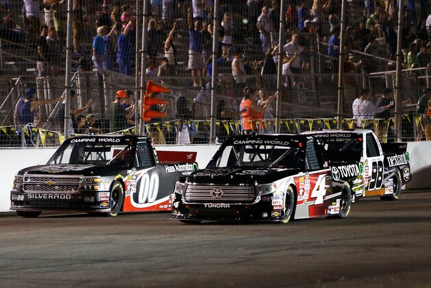 Cole Custer (00) and Erik Jones (4) make their way around the track during the NASCAR Truck Series auto race at Gateway Motorsports Park Saturday, June 13, 2015, in Madison, Ill. (AP Photo/Scott Kane)