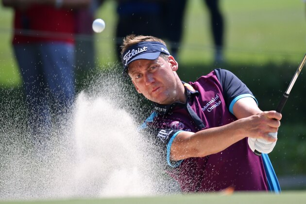 Ian Poulter of England hits out of a bunker on the 9th hole during round 2 at the Hong Kong Open golf tournament, Friday, Oct. 23, 2015. (AP Photo/Kin Cheung)