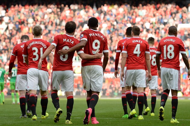 United players walk back to the half way line, after scoring their third goal during the English Premier League football match between Manchester United and Sunderland at Old Trafford in Manchester, north west England, on September 26, 2015. Manchester United won the game 3-0. AFP PHOTO / OLI SCARFF

RESTRICTED TO EDITORIAL USE. No use with unauthorized audio, video, data, fixture lists, club/league logos or 'live' services. Online in-match use limited to 75 images, no video emulation. No use in betting, games or single club/league/player publications.        (Photo credit should read OLI SCARFF/AFP/Getty Images)