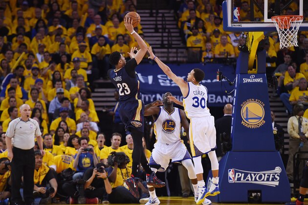 OAKLAND, CA - APRIL 20:  Anthony Davis #23 of the New Orleans Pelicans shoots over Stephen Curry #30 of the Golden State Warriors in the second quarter during the first round of the 2015 NBA Playoffs at ORACLE Arena on April 20, 2015 in Oakland, California. NOTE TO USER: User expressly acknowledges and agrees that, by downloading and or using this photograph, User is consenting to the terms and conditions of the Getty Images License Agreement.  (Photo by Thearon W. Henderson/Getty Images)
