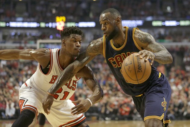Cleveland Cavaliers forward LeBron James (23) drives on Chicago Bulls guard Jimmy Butler (21) during the first half of Game 6 in a second-round NBA basketball playoff series in Chicago on Thursday, May 14, 2015. (AP Photo/Nam Y. Huh)