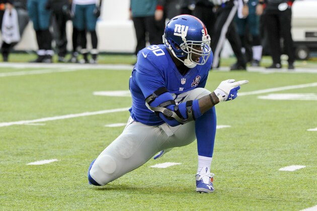 New York Giants' Jason Pierre-Paul (90) reacts to sacking Philadelphia Eagles' Mark Sanchez during the first half of an NFL football game Sunday, Dec. 28, 2014, in East Rutherford, N.J. (AP Photo/Bill Kostroun)