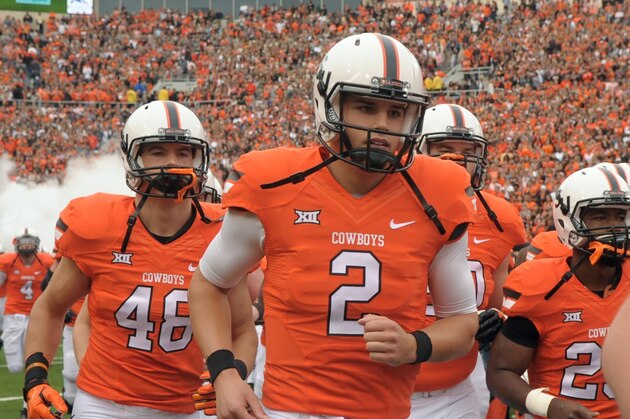 Oklahoma State quarterback Mason Rudolph (2) jogs onto the field at the start of an NCAA college football game between Kansas and Oklahoma St in Stillwater, Okla., Saturday, Oct. 24, 2015.(AP Photo/Brody Schmidt)