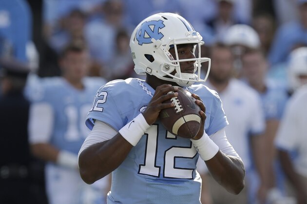 North Carolina quarterback Marquise Williams (12) looks to pass against Virginia during the first half of an NCAA college football game in Chapel Hill, N.C., Saturday, Oct. 24, 2015. (AP Photo/Gerry Broome)