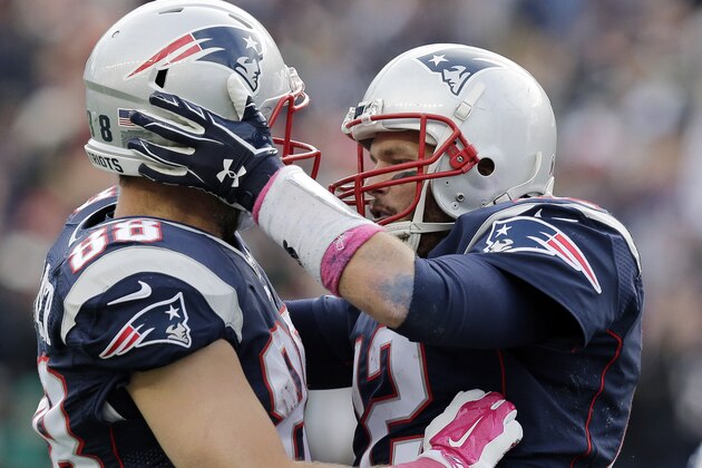New England Patriots quarterback Tom Brady (12) celebrates his touchdown pass to Rob Gronkowski with tight end Scott Chandler (88) during the second half of an NFL football game against the New York Jets, Sunday, Oct. 25, 2015, in Foxborough, Mass. (AP Photo/Charles Krupa)