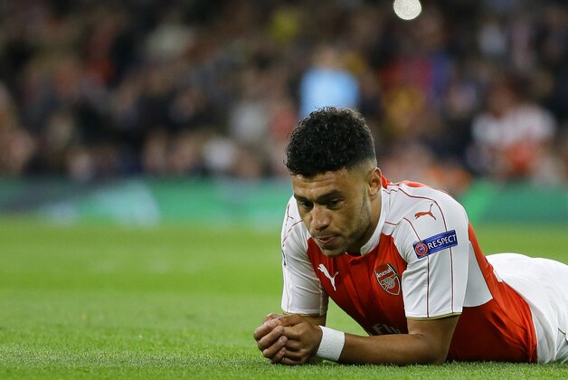 Arsenal's Alex Oxlade-Chamberlain lays on the pitch after missing a chance during the Champions League Group F soccer match between Arsenal and Olympiakos at Emirates stadium in London Tuesday, Sept. 29, 2015. (AP Photo/Kirsty Wigglesworth)