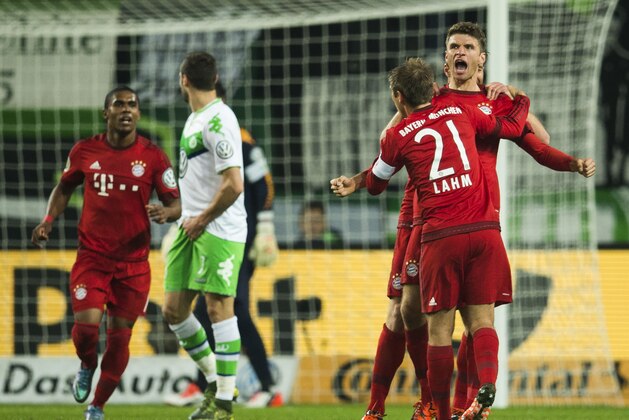 Bayern Munich's forward Thomas Mueller (R) celebrates scoring his side's 2nd goal during the German Cup DFB Pokal second round football match between VfL Wolfsburg vs FCB Bayern Munich in Wolfsburg, on October 27, 2015. AFP PHOTO / ODD ANDERSEN

RESTRICTIONS / EMBARGO  ACCORDING TO DFB RULES IMAGE SEQUENCES TO SIMULATE VIDEO IS NOT ALLOWED DURING MATCH TIME. MOBILE (MMS) USE IS NOT ALLOWED DURING AND FOR FURTHER TWO HOURS AFTER THE MATCH. FOR MORE INFORMATION CONTACT DFB DIRECTLY AT +49 69 67880.        (Photo credit should read ODD ANDERSEN/AFP/Getty Images)