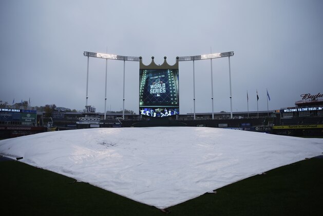 A tarp protects the infield from rain before Game 1 of the Major League Baseball World Series between the New York Mets and Kansas City Royals, Tuesday, Oct. 27, 2015, in Kansas City, Mo. (AP Photo/Matt Slocum)