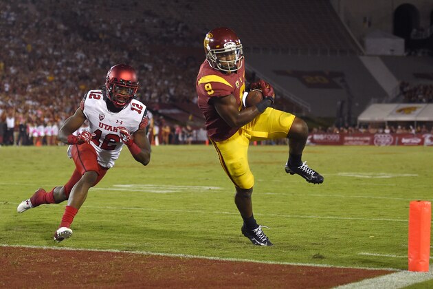 Southern California wide receiver JuJu Smith-Schuster, right, heads in for a touchdown under pressure from Utah defensive back Justin Thomas during the second half of an NCAA college football game, Saturday, Oct. 24, 2015, in Los Angeles. Southern California won 42-24. (AP Photo/Mark J. Terrill)