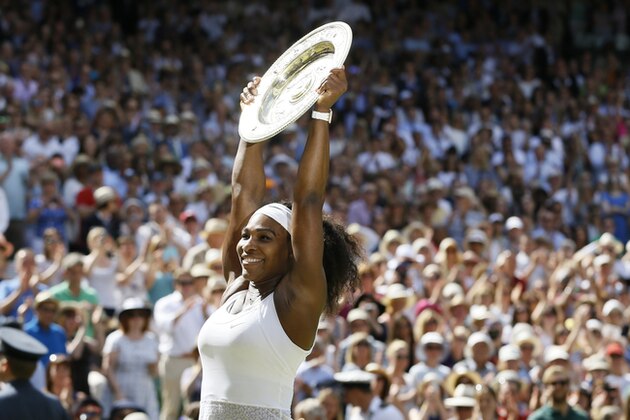 Serena Williams of the United States holds up the trophy after winning the women's singles final against Garbine Muguruza of Spain, at the All England Lawn Tennis Championships in Wimbledon, London, Saturday July 11, 2015. (AP Photo/Kirsty Wigglesworth)