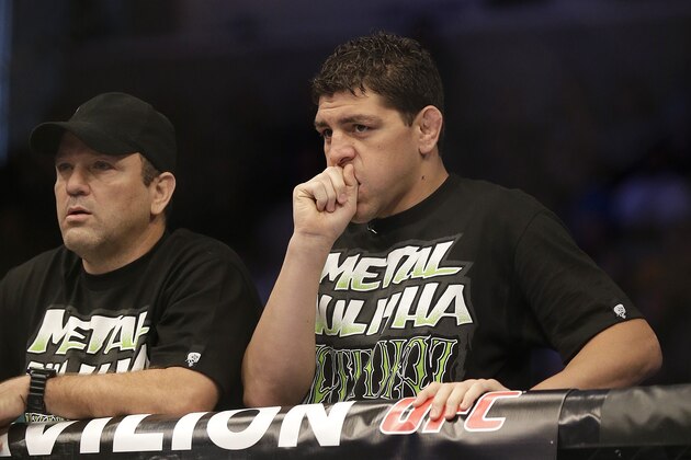 Nick Diaz, right, and Cesar Gracie stand in the corner of Nate Diaz before a UFC lightweight mixed martial arts fight between Nate Diaz and Josh Thomson in San Jose, Calif., Saturday, April 20, 2013. (AP Photo/Jeff Chiu)