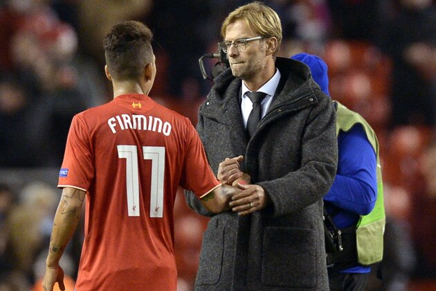 Liverpool's German manager  Jurgen Klopp (R) shakes hands with Liverpool's Brazilian midfielder Roberto Firmino  after a   UEFA Europa League group B football match between Liverpool FC and FC Rubin Kazan at Anfield in Liverpool, north west England, on October 22, 2015.  AFP PHOTO / OLI SCARFF        (Photo credit should read OLI SCARFF/AFP/Getty Images)