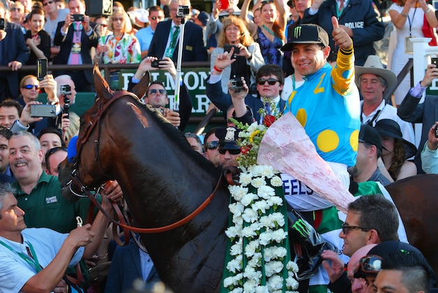 Jun 6, 2015; Elmont, NY, USA; American Pharoah with jockey Victor Espinoza in the winner's circle after winning the 2015 Belmont Stakes at Belmont Park. American Pharoah won all three legs of the Triple Crown. Mandatory Credit: Brad Penner-USA TODAY Sports