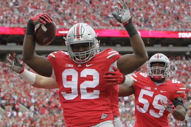 Ohio State defensive lineman Adolphus Washington, left, celebrates his touchdown against Western Michigan during the second quarter of an NCAA college football game, Saturday, Sept. 26, 2015, in Columbus, Ohio. (AP Photo/Jay LaPrete)