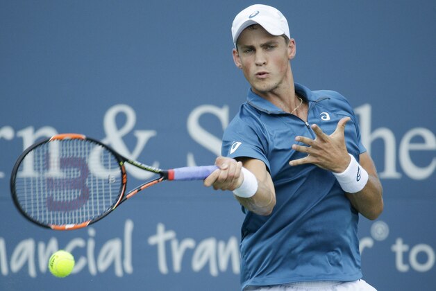 Vasek Pospisil, of Canada, returns the ball to Hyeon Chung, of Korea, during the qualifying round at the Western & Southern Open tennis tournament, Sunday, Aug. 16, 2015, in Mason, Ohio. (AP Photo/John Minchillo)