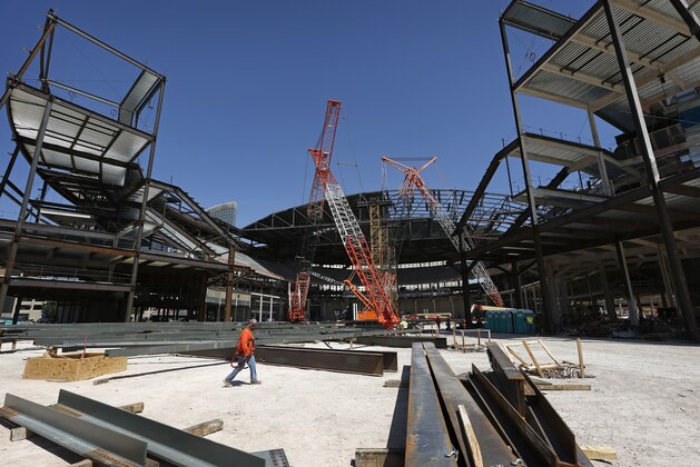 A worker walks through an MGM arena being built behind the New York-New York casino-hotel on the Strip Tuesday, April 7, 2015, in Las Vegas. The $375 million arena is still looking for a stadium naming rights sponsor and possible NHL team franchise. (AP Photo/John Locher)