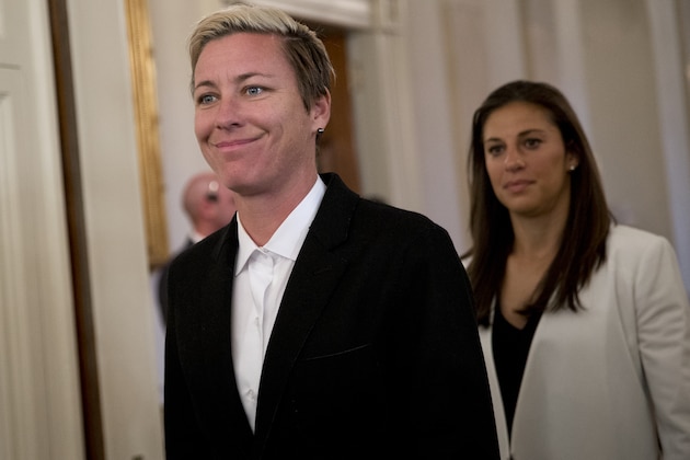 United States Women's National Soccer Team players Abby Wambach, left, and Carli Lloyd arrive with their team for a ceremony in the East Room of the White House in Washington Tuesday, Oct. 27, 2015, where President Barack Obama will honor the United States Women's National Soccer Team and their victory in the 2015 FIFA Women's World Cup. Wambach, the leading career scorer, male or female, in international soccer, announced her retirement from soccer on Tuesday, Oct. 27, 2015, shortly after the U.S. national team celebrated its Women's World Cup victory at the White House. (AP Photo/Carolyn Kaster)