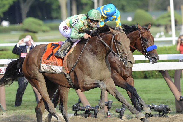 Keen Ice (7), with jockey Javier Castellano, moves past Triple Crown winner American Pharoah, with Victor Espinoza, to win the Travers Stakes horse race at Saratoga Race Course in Saratoga Springs, N.Y., Saturday, Aug. 29, 2015. (AP Photo/Hans Pennink)