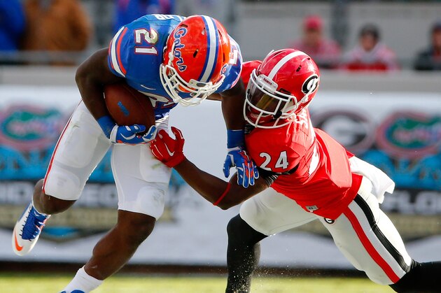 JACKSONVILLE, FL - NOVEMBER 01: Dominick Sanders #24 of the Georgia Bulldogs attempts to tackle Kelvin Taylor #21 of the Florida Gators during the game at EverBank Field on November 1, 2014 in Jacksonville, Florida.  (Photo by Sam Greenwood/Getty Images)
