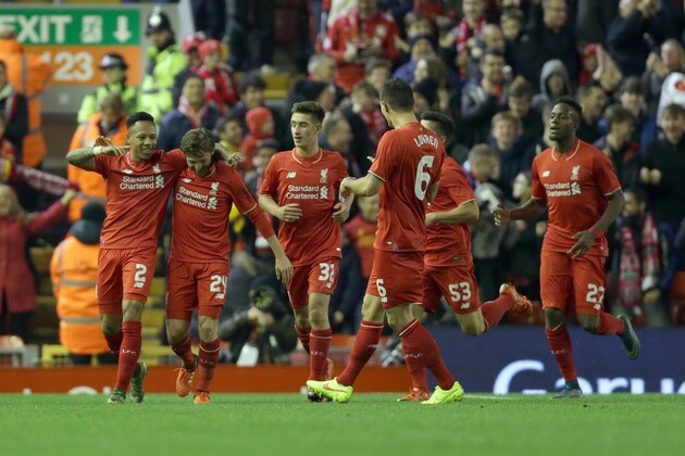 Liverpool's Nathaniel Clyne left, celebrates with his team-mates after he scores the first goal for his side during their English League Cup Fourth Round soccer match against Bournemouth at Anfield in Liverpool, England, Wednesday Oct. 28, 2015. (AP Photo/Clint Hughes)