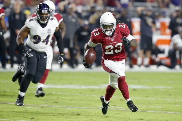 Arizona Cardinals running back Chris Johnson (23) runs for a touchdown as Baltimore Ravens defensive end Carl Davis (94) looks on during the first half of an NFL football game, Monday, Oct. 26, 2015, in Glendale, Ariz. (AP Photo/Rick Scuteri)