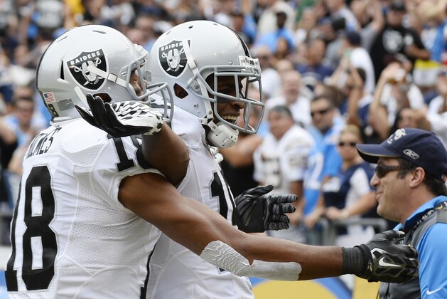 Oakland Raiders wide receiver Michael Crabtree, center, celebrates his touchdown with teammate wide receiver Andre Holmes, left, during the second half of an NFL football game against the San Diego Chargers, Sunday, Oct. 25, 2015, in San Diego. (AP Photo/Denis Poroy)