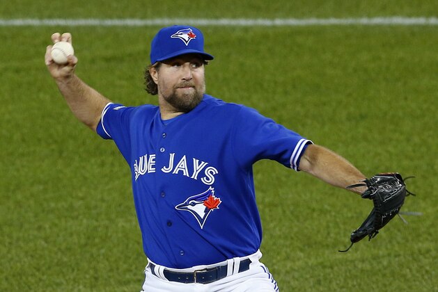 Toronto Blue Jays starting pitcher R.A. Dickey throws against the Kansas City Royals during the first inning in Game 4 of baseball's American League Championship Series on Tuesday, Oct. 20, 2015, in Toronto. (AP Photo/Paul Sancya)