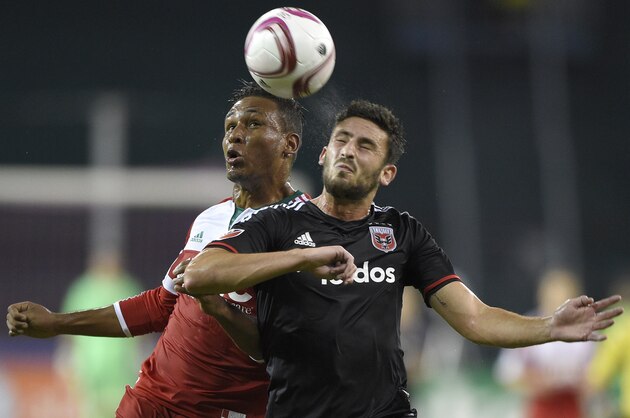 New England Revolution forward Juan Agudelo (17) battles for the ball against D.C. United defender Steve Birnbaum (15) during the first half of an MLS playoff soccer game, Wednesday, Oct. 28, 2015, in Washington. (AP Photo/Nick Wass)