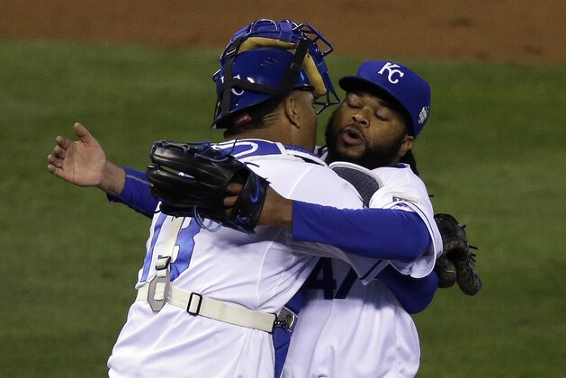 Kansas City Royals catcher Salvador Perez celebrates with Johnny Cueto after Game 2 of the Major League Baseball World Series against the New York Mets Wednesday, Oct. 28, 2015, in Kansas City, Mo. The Royals won 7-1 to take a 2-0 lead in the series. (AP Photo/David Goldman)