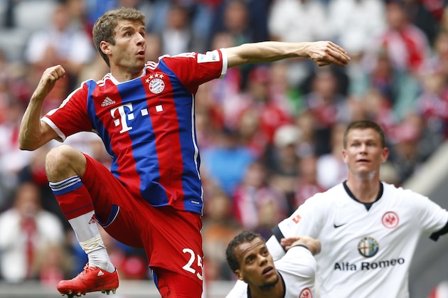 Bayern's Thomas Mueller jumps for the ball during the German first division Bundesliga soccer match between FC Bayern Munich and Eintracht Frankfurt in the Allianz Arena in Munich, Germany, on Saturday, April 11, 2015. (AP Photo/Matthias Schrader)