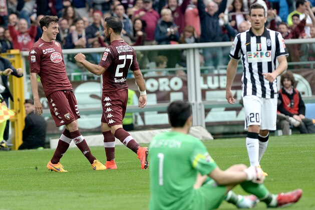 Torino's Matteo Darmian, left, celebrates after scoring during a Serie A soccer match between Torino and Juventus at the Olympic stadium, in Turin, Italy, Sunday, April 26, 2015. (AP Photo/Massimo Pinca)