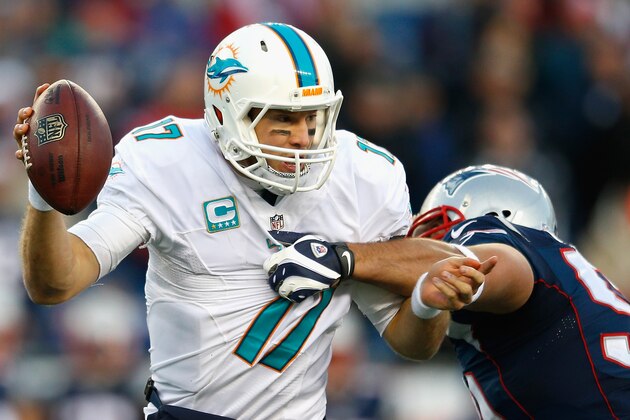 FOXBORO, MA - DECEMBER 14:  Ryan Tannehill #17 of the Miami Dolphins is sacked during the fourth quarter against the New England Patriots at Gillette Stadium on December 14, 2014 in Foxboro, Massachusetts.  (Photo by Jim Rogash/Getty Images)
